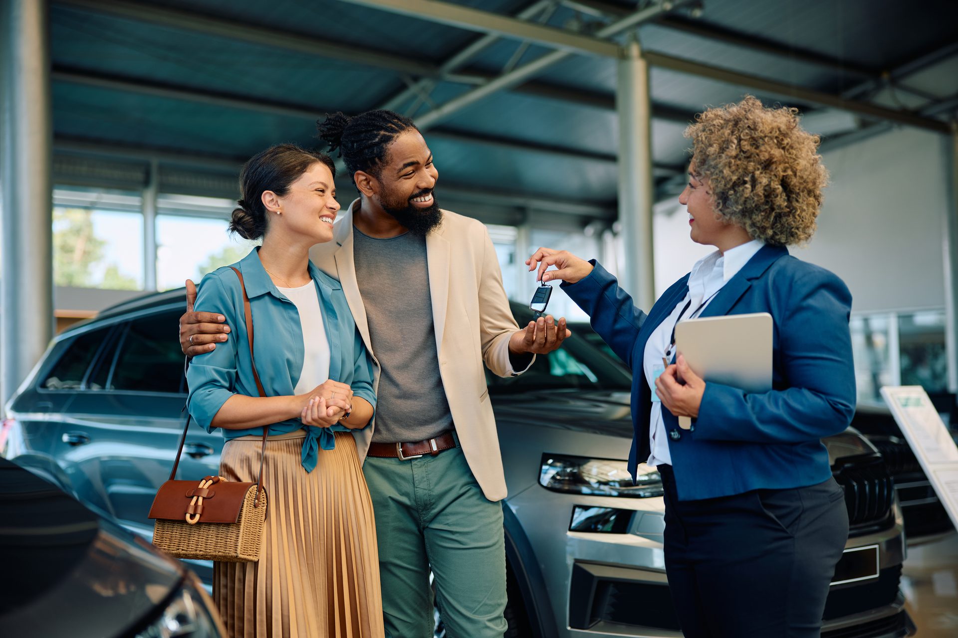 Couple receiving the keys to their new car