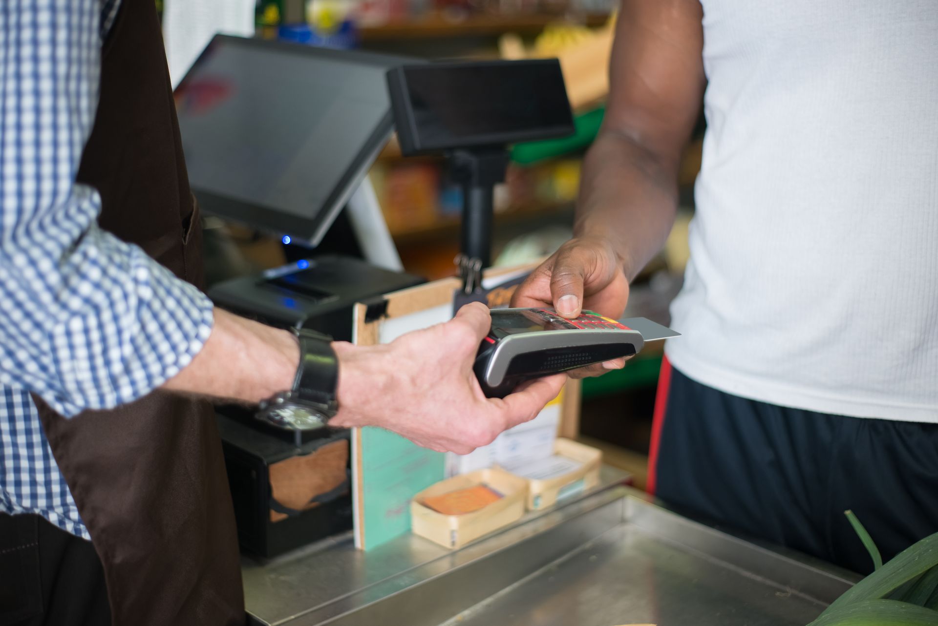 Customer paying by card at a small business checkout