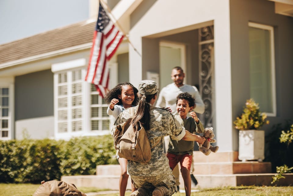 Servicewoman embracing her children during a homecoming