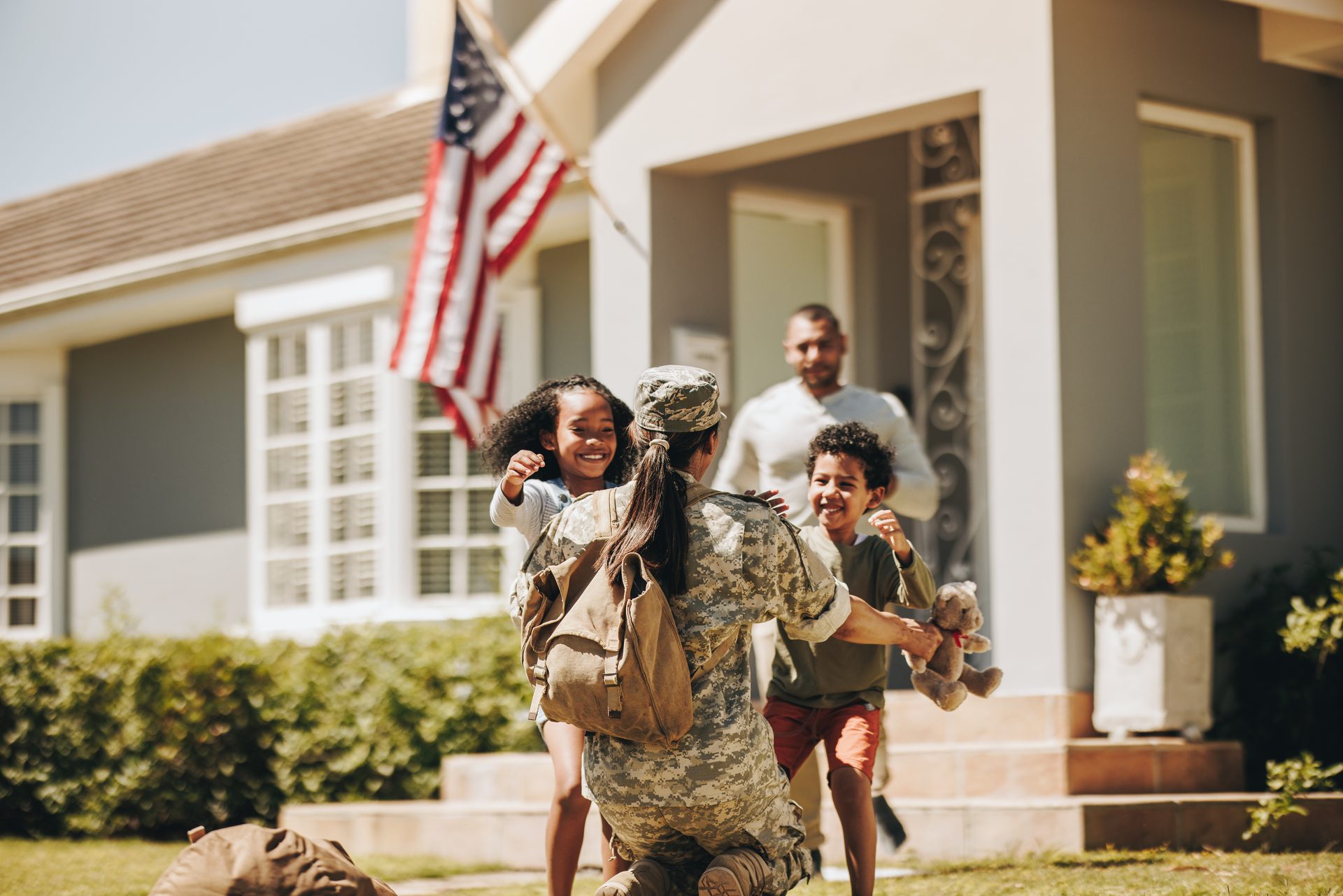 Servicewoman embracing her children during a homecoming