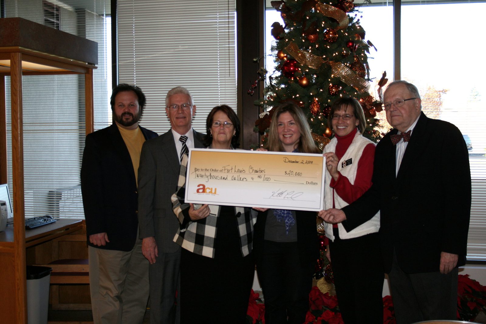 Ken Leonard and community partners present a $20,000 ACU check to Fort Lewis Charities