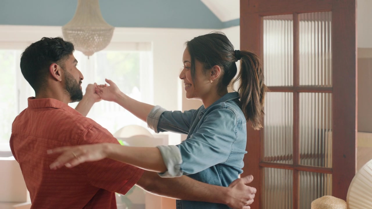 Couple dancing together in their new home