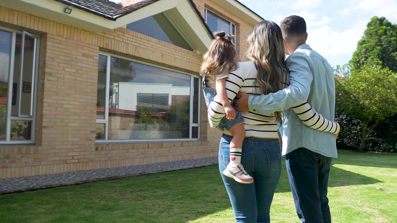 Family standing outside their new home