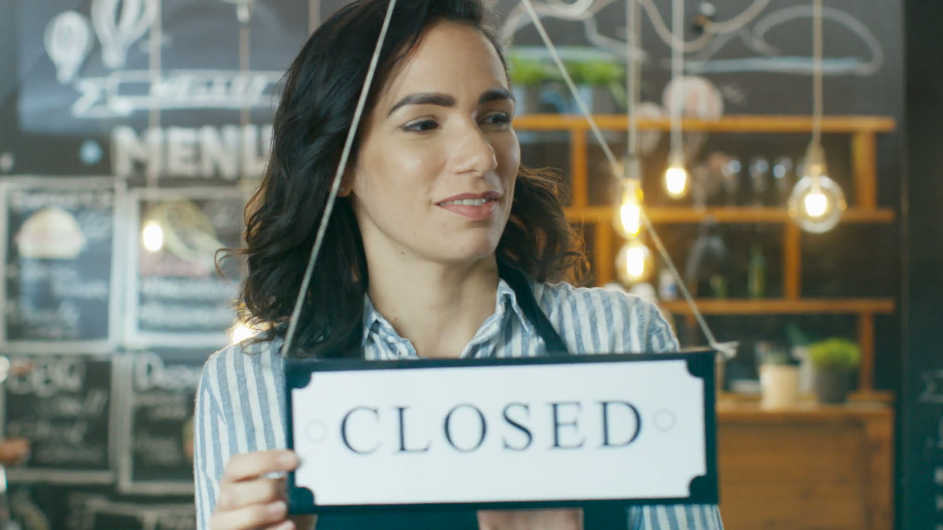 Cafe owner turning the storefront sign to open