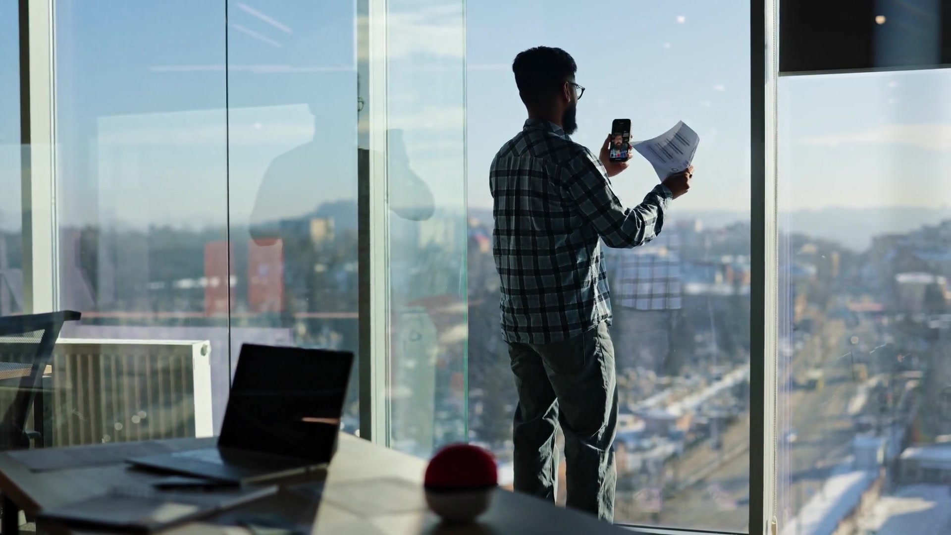 Business owner photographing a check with a smartphone to deposit it