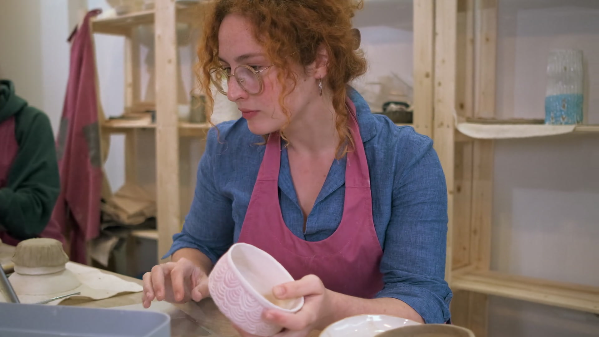 Business owner using a laptop in her pottery studio