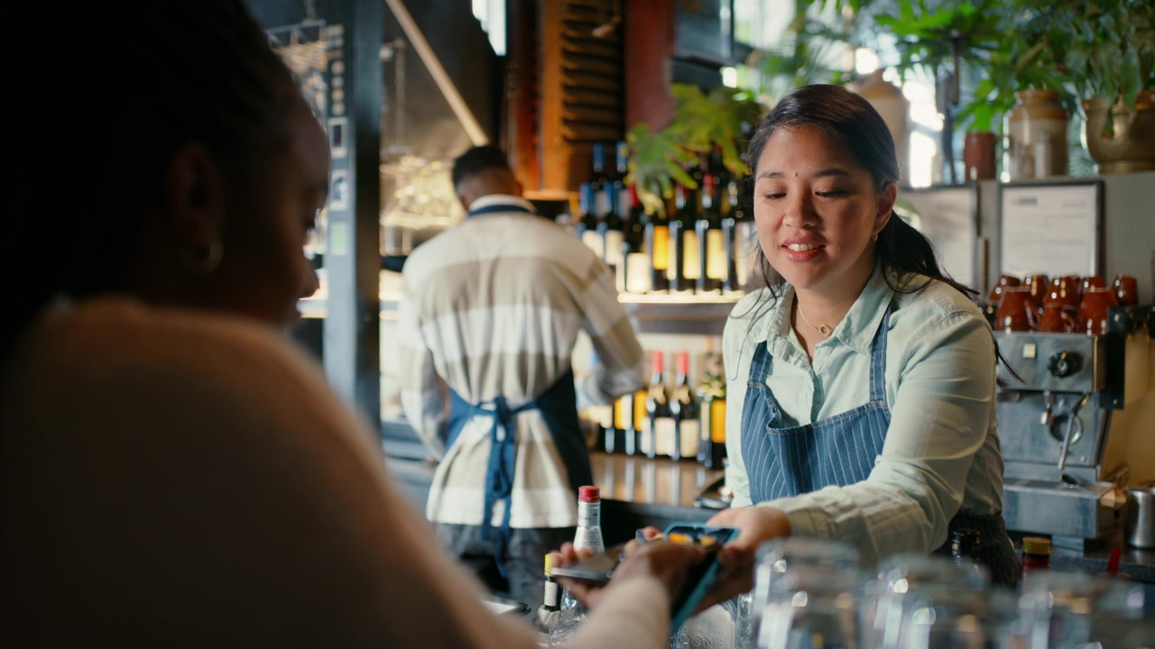 Member paying with a card at a cafe counter