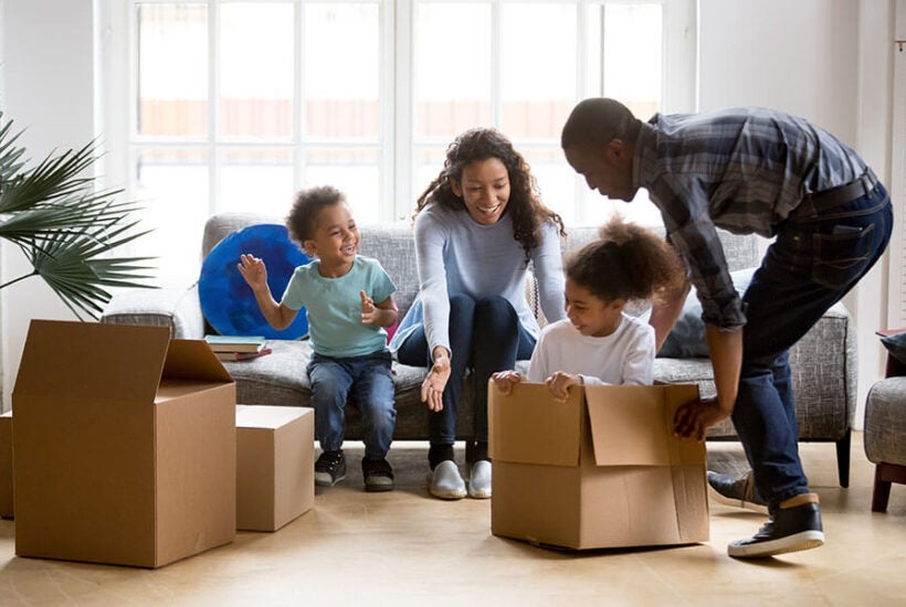 A family moves into their new home purchased with a FHA loan.
