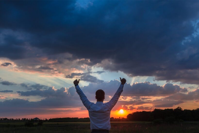 A city business man is excited to watch the sunset on his new land bought with a land loan.