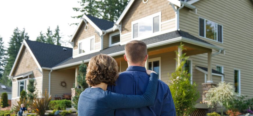 A young couple looks at their new home, confident that they are prepared to buy a house while owning another one.