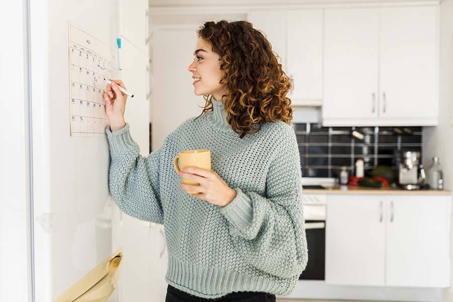 A woman marks the date she can draw funds from her performance saver account.