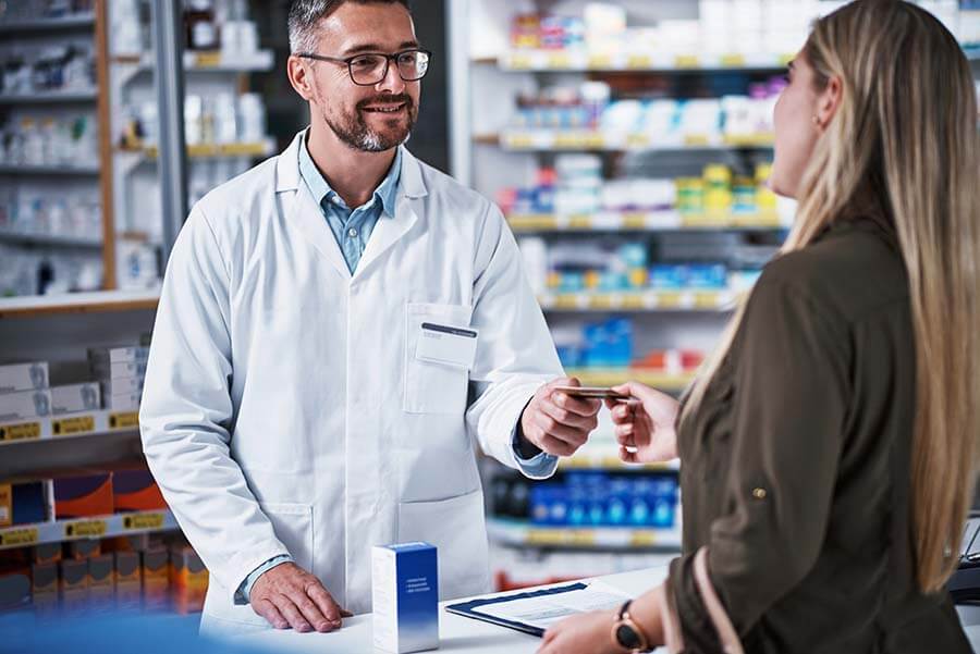 A woman pays for medication using funds from a Health Savings Account.