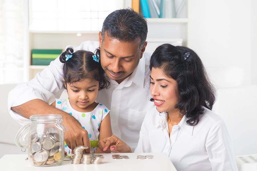 Parents teach a child money management with a children's savings account.