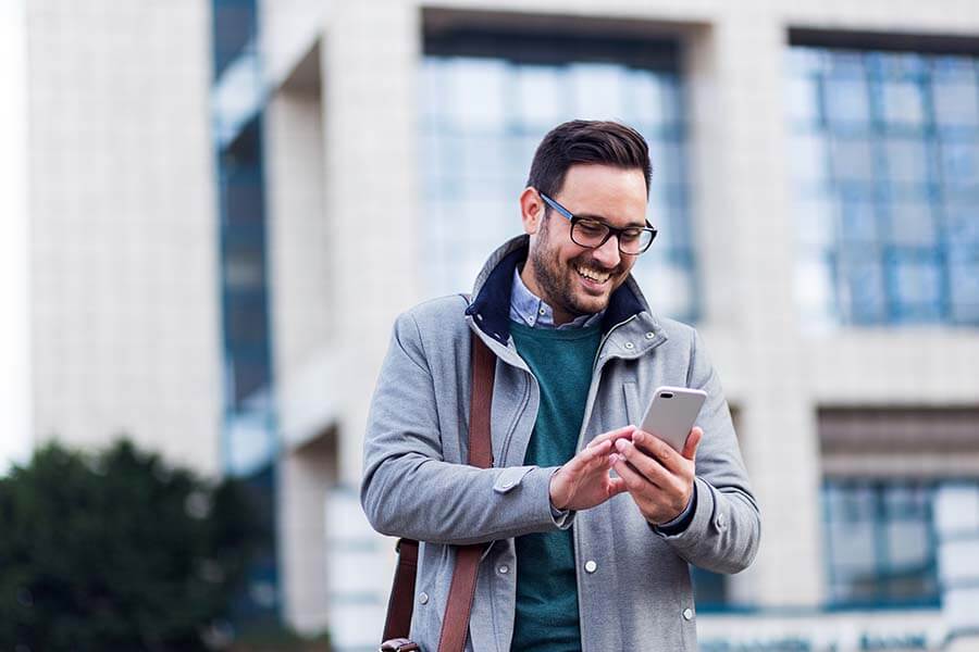 Man using his ACU Card App to control his credit card on his smartphone