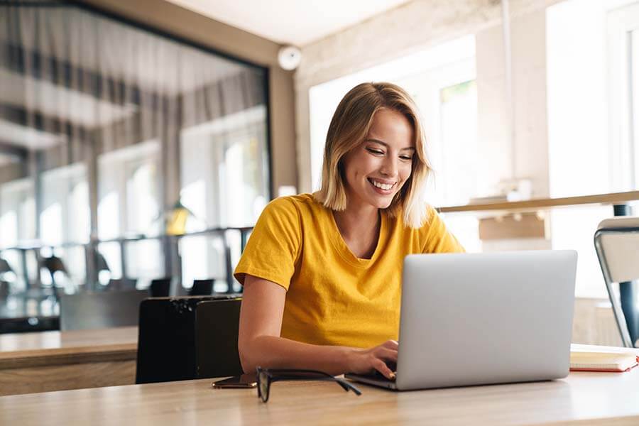 Woman using online banking on her computer to check her finances