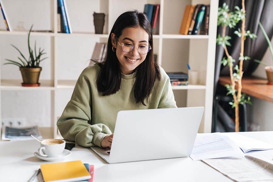 A student is smiling after her teen account was converted to a regular savings account when she turned 18.