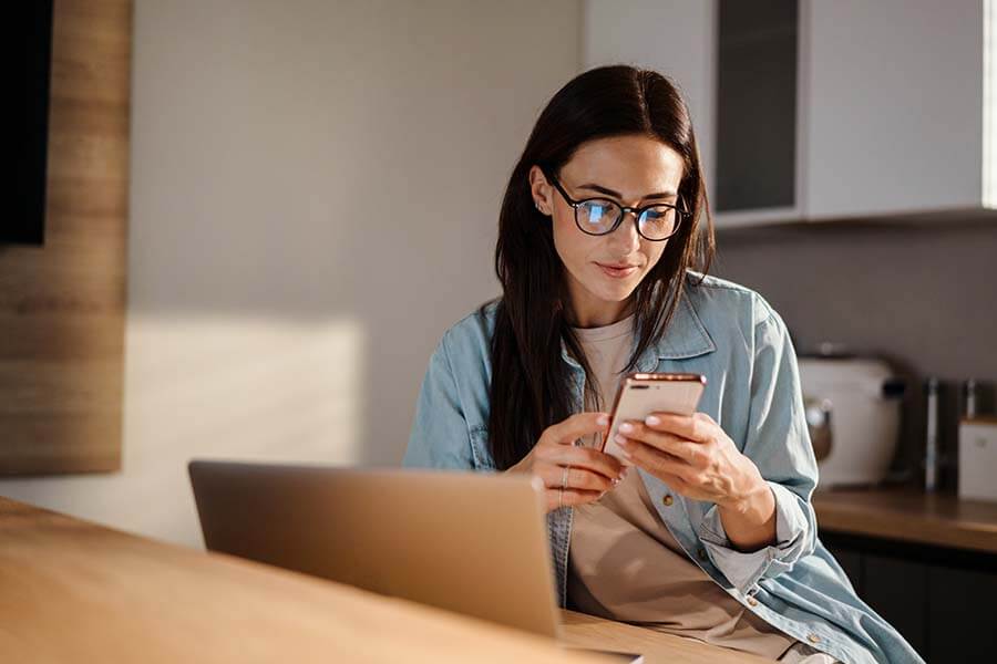 Woman using mobile banking to control her finances with her smartphone