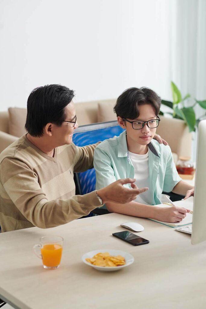 A teenager learns money management skills from his dad while using his teen savings account.