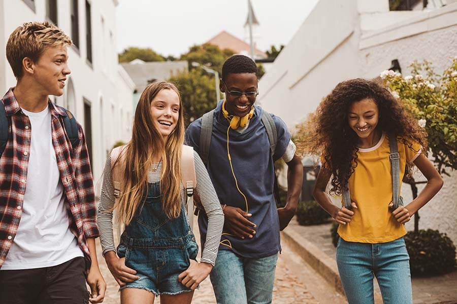 A group of teens walking home from school.