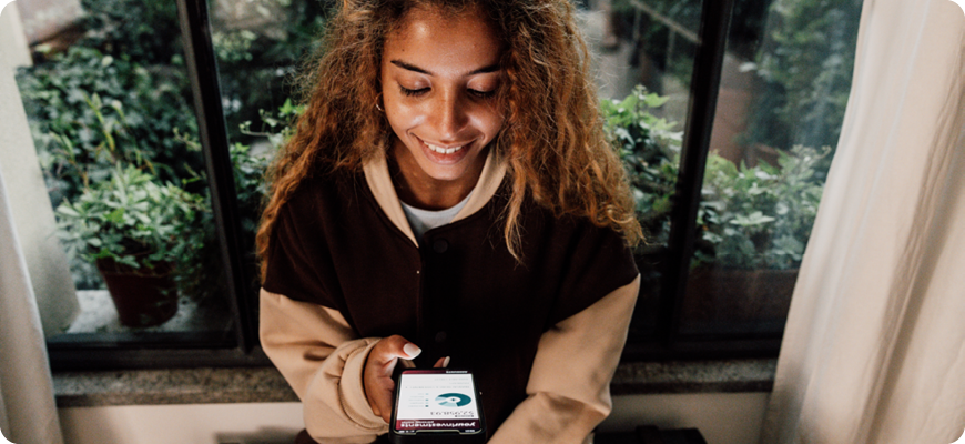 Young woman investing on her phone